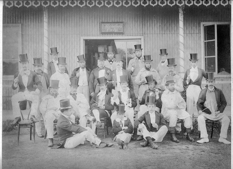 The club in full Victorian dress, c. 1880s โ top hats, frock coats and clay pipes at the pavilion.